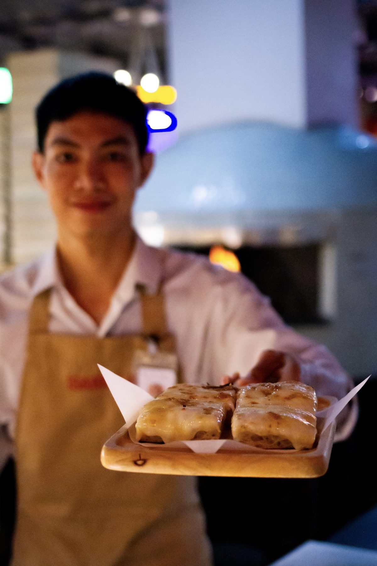 Isabella by Andreas server presenting Pala Romana pizza slices
